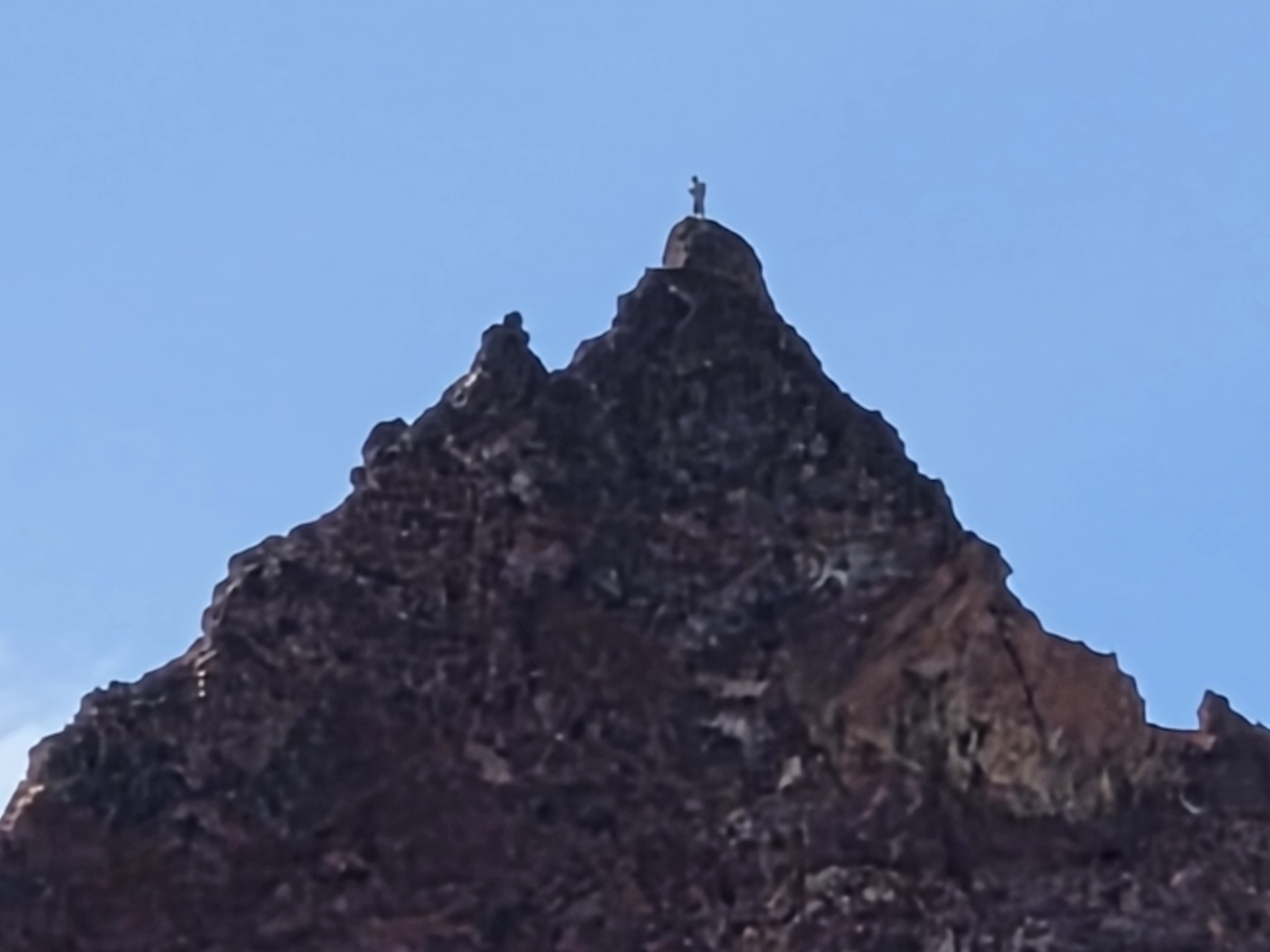 A climber stands on the summit of Broken Top—something we had never witnessed on our previous hikes here.